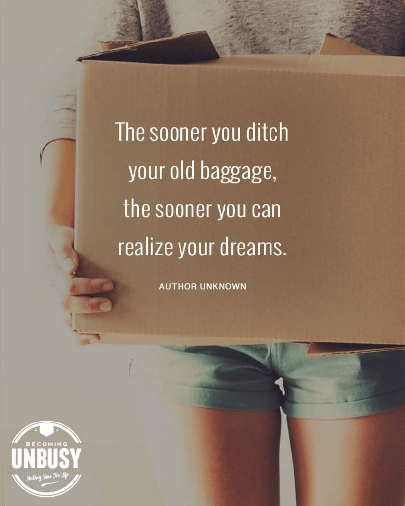 A women holding a cardboard box with the minimalism quote, "The sooner you ditch your old baggage, the sooner you can realize your dreams."