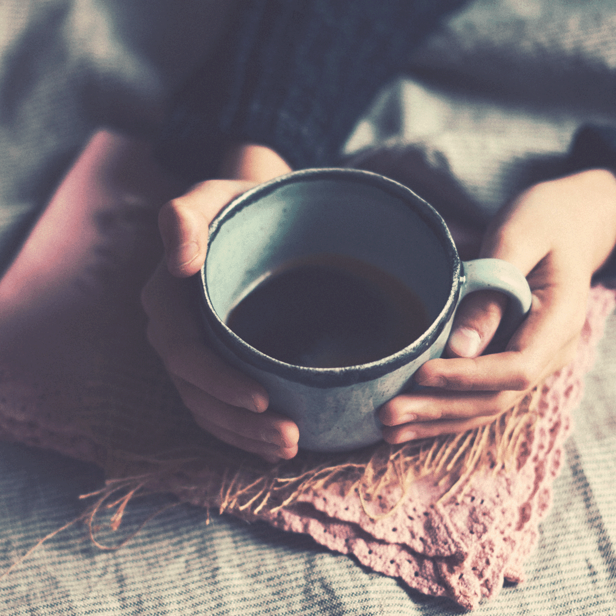 A woman holding a coffee mug.