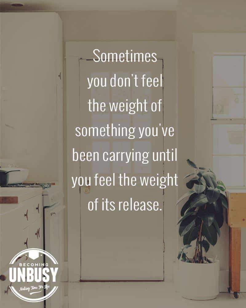 A white kitchen back door with a quote about how to start over written overtop reading, "Sometimes you don't feel the weight of something you've been carrying until you feel the weight of its release."