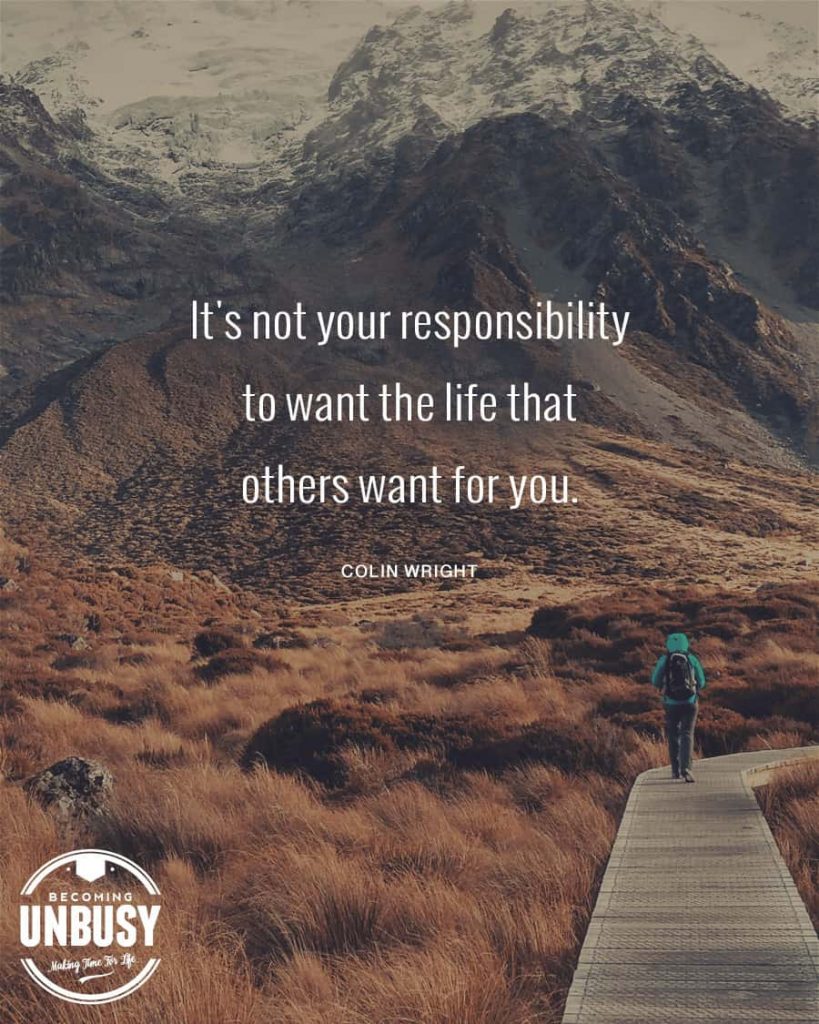 A woman walking on a wood path in the moutains with a quote about change written overtop reading, "It is not your responsibility to want the life others want for you."