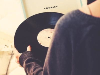 A woman holding an analog record.