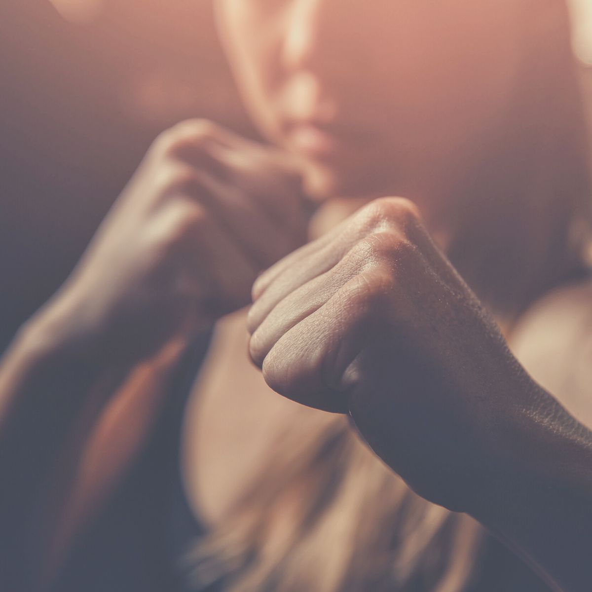 Woman with her fist raised ready for a challenge.