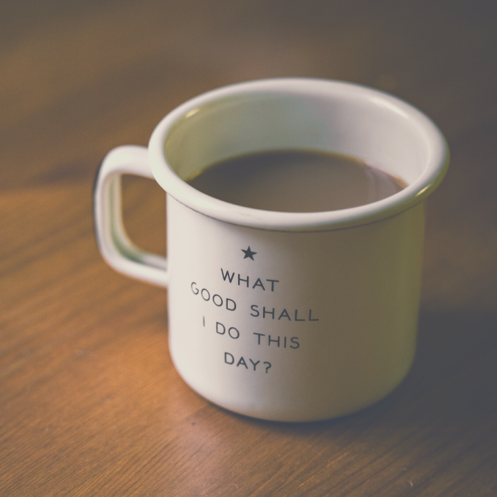 A full coffee mug with the Enneagram 2 phrase "what good shall i do this day?" written on it.