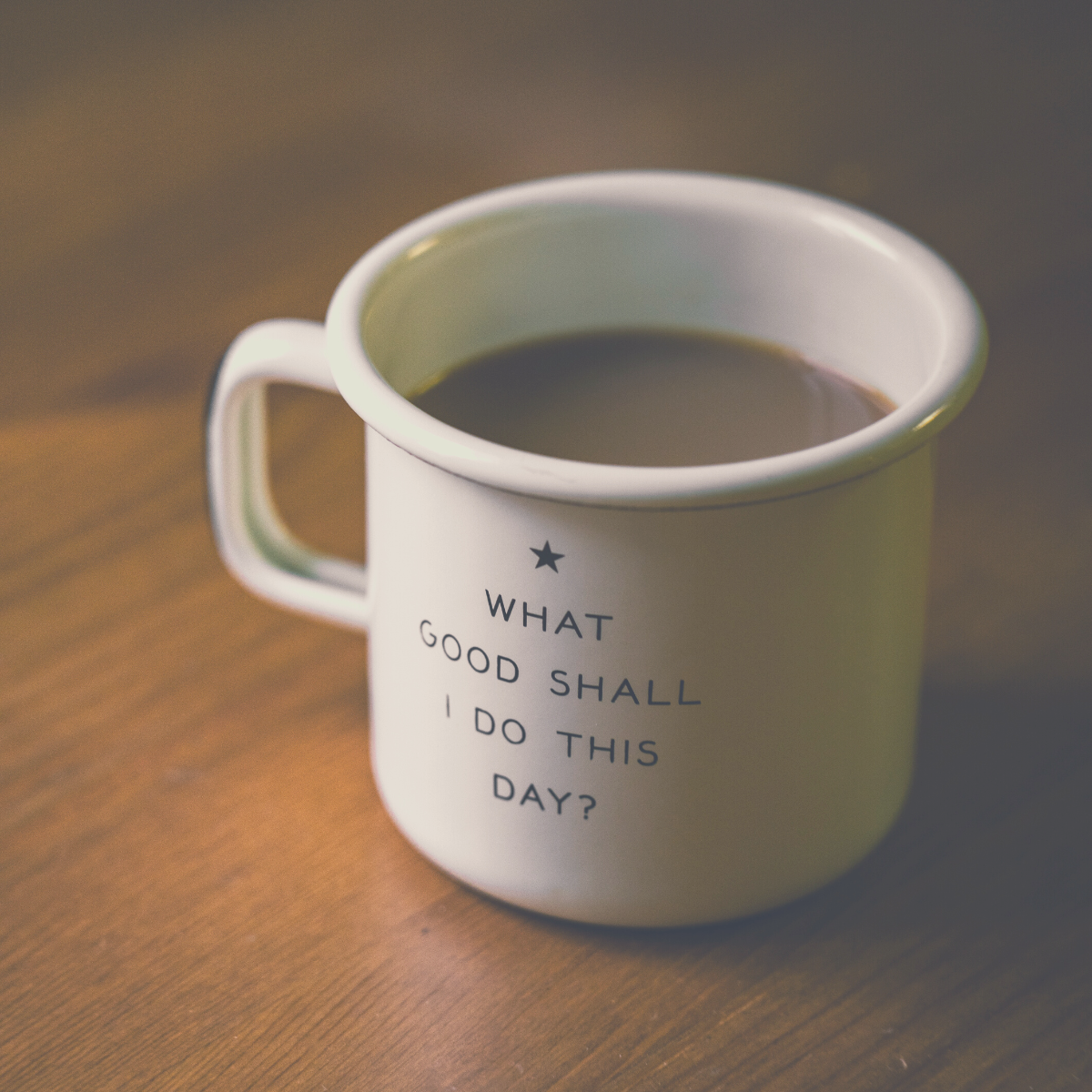 A full coffee mug with the Enneagram 2 phrase "What good shall i do this day?" written on it.