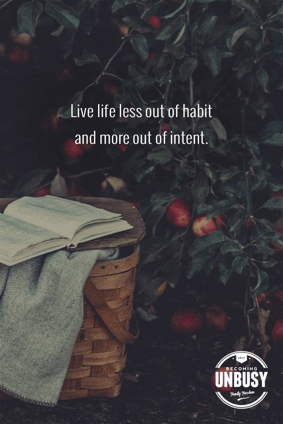 The following fall bucket list quote written over a photo of a picnic basket and book at an apple orchard, "Live life less out of habit and more out of intent."