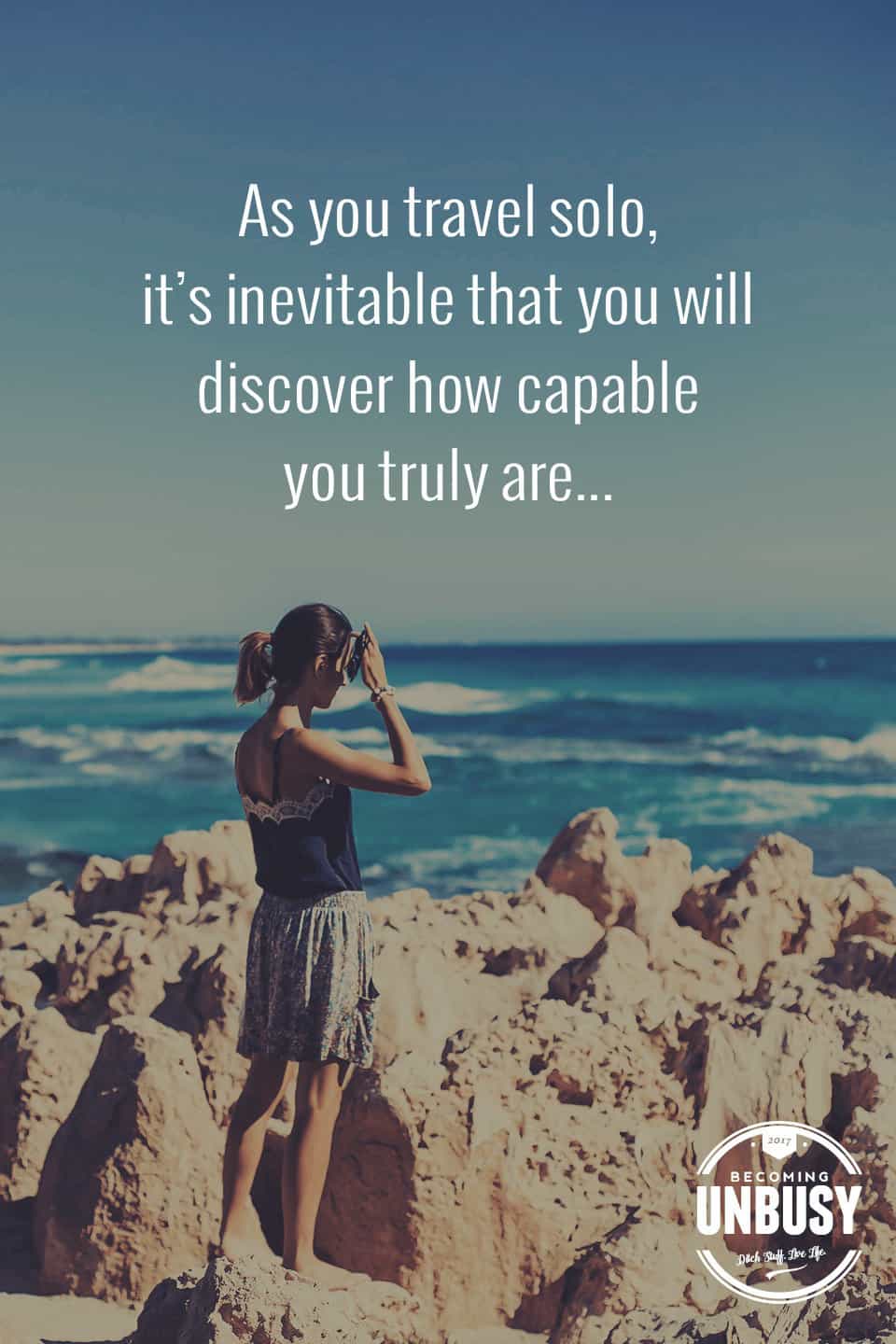 The following winter self-care quote over a photo of a woman alone on a beach, "As you travel solo, it's inevitable that you will discover how capable you are..."