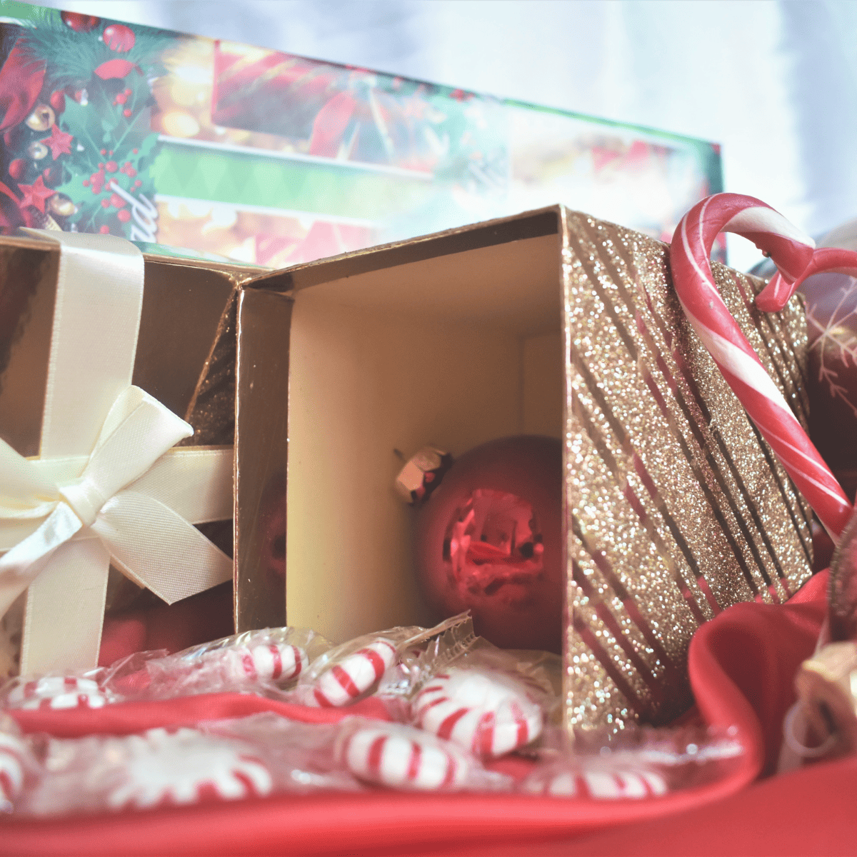 A collection of Christmas wrapping clutter, candy canes, ribbons, and paper.